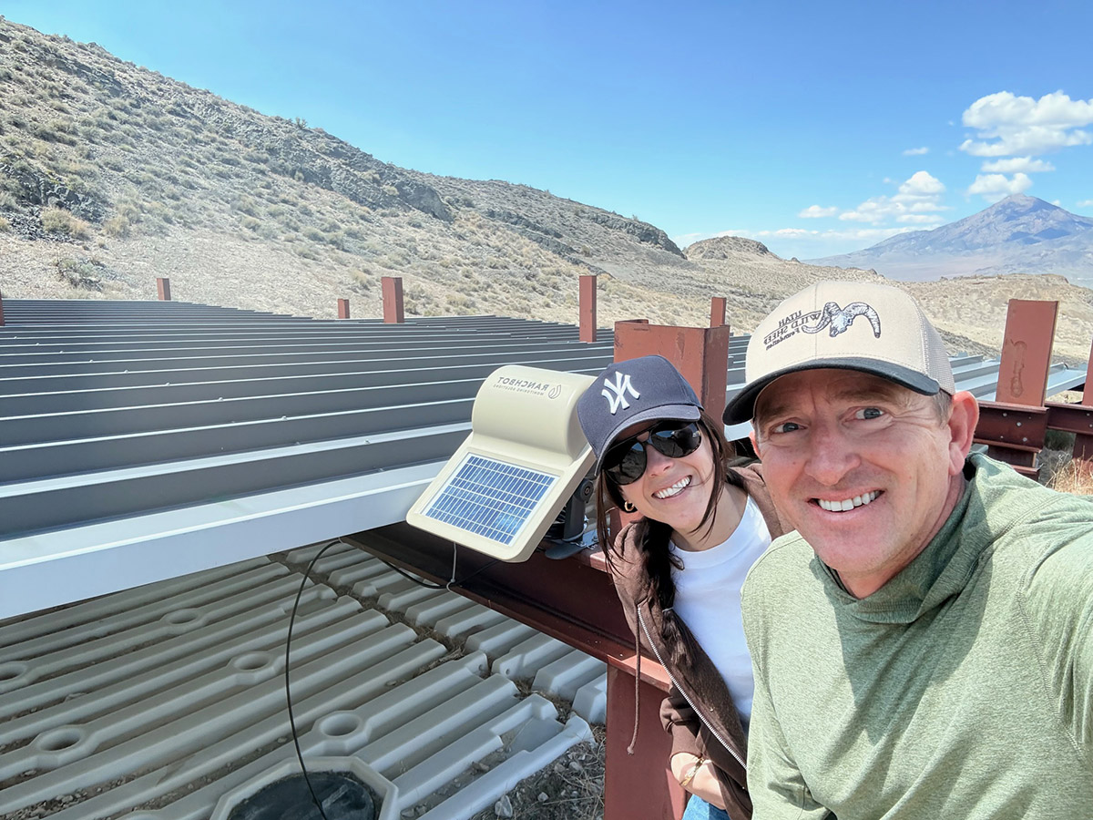 Travis Jenson (Utah WSF President) and Hadli Sorenson (Utah WSF Executive Director) pose in front of a recently constructed water guzzler with integrated Ranchbot technology